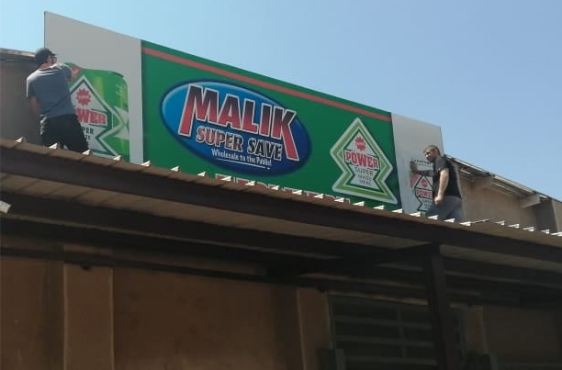 Rooftop board signage for Malik Super Save
